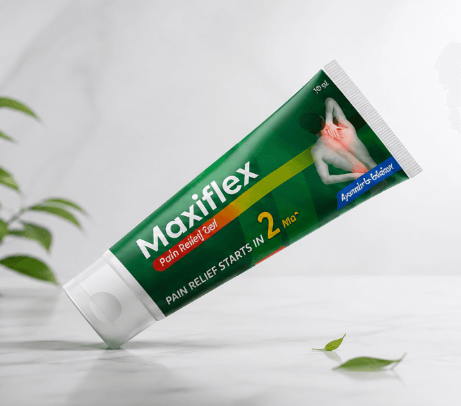 Tube of Maxiflex pain relief gel resting on a white surface beside green leaves